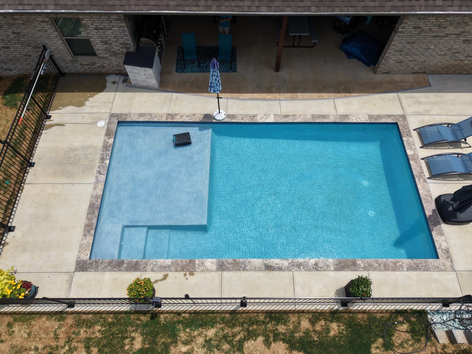 Overhead view of a rectangular lap pool with a large tanning ledge and wide entry steps